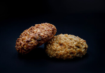 Fresh oatmeal cookies on a dark background.