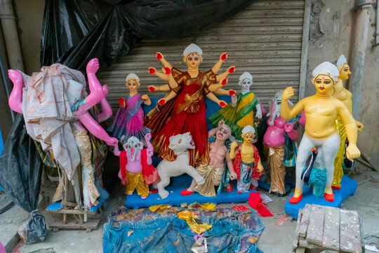 Kolkata, West Bengal, India - 7th October 2018 : Clay idol of Goddess Durga, under preparation for "Durga Puja' festival in Kumartuli. Mother with her children as Laxmi, Ganesha, Kartik and Saraswati.