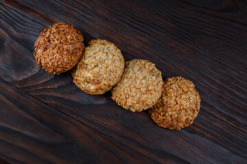 Oatmeal cookies laid out in a row on a wooden board top view. Rustic oatmeal cookies.