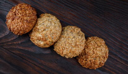 Oatmeal cookies laid out in a row on a wooden board top view. Rustic oatmeal cookies.