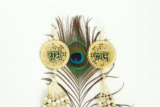 sign with indian hindi text shubh labh(means goodness and benefits)and peacock feather hindu religion holy symbols