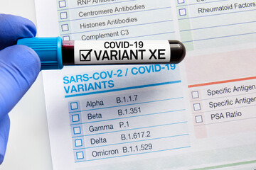 Blood sample tube with positive of New Variant of the Covid-19 XE. Blood tube over requisition form...