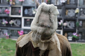 Unrecognizable psycho wearing stitched sack mask