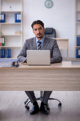 Young male employee working in the office