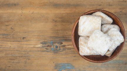 short pastry cookies in wood bowl, sprinkled with powdered sugar. ready-made shortbread.