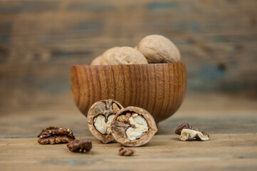 bowl full of delicious and fresh walnuts on an old wooden table