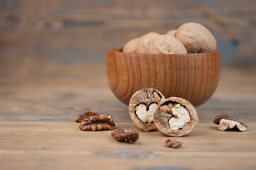 bowl full of delicious and fresh walnuts on an old wooden table