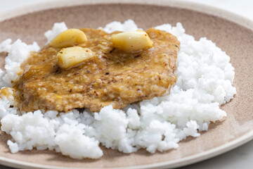 Fototapeta na wymiar pork cutlet with garlic and rice
