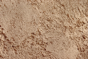 Texture crépis beige rosé sur façade d'un mur