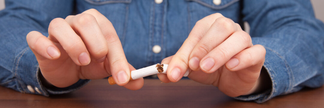 Female breaking a cigarette with fingers