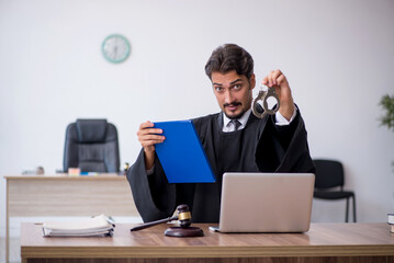 Young male judge working in the courthouse