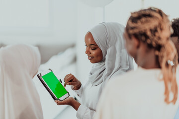 Group of happy african students having conversation and team meeting working together on homework girls wearing traidiional sudan muslim hijab fashion