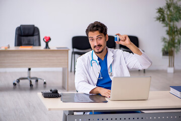 Young male doctor working in the clinic