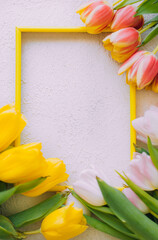 Tulips and a frame on a gray background . Tulips of kopi space. Gray background. Mockup . Space for text. A greeting card. Tulips on a gray background. Spring flowers.