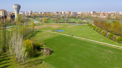 Fototapeta na wymiar Aerial view of the Resistance park in Modena, Italy. In the background you can see the city and in particular the Ghirlandina tower.