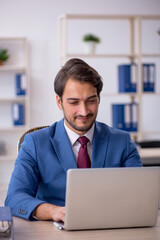 Young male employee and too much work in the office