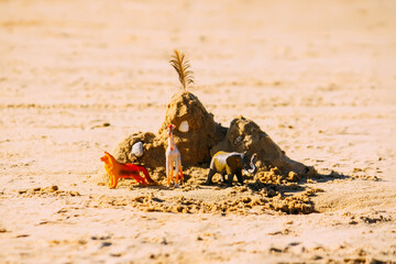 Plastic toys on sand. 