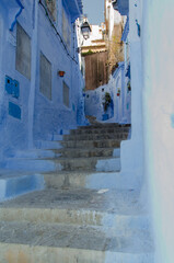 Calle con escaleras en Chaouen, Marruecos, turismo en pueblo azul encalado - 497559942