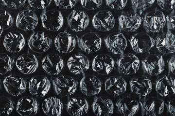 The texture of the packaging air-bubble film on a Black background in full screen