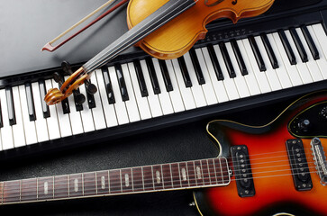 Synthesizer keyboard, violin and electric guitar.
