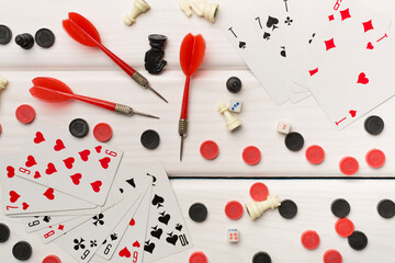 Different board games on wooden background, top view