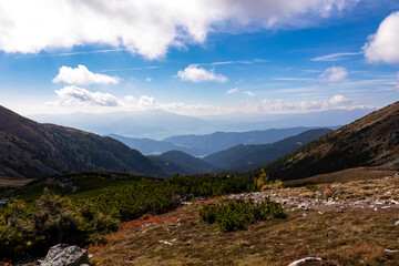Panoramic view on Mur valley from Seckauer Zinken in the Lower Tauern in Styria, Austria, Europe. Sunny golden autumn day in Seckau Alps. Hiking trail on dry and bare grassland terrain. Soft hills