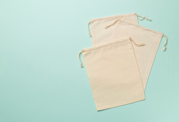Small eco sacks on color background. Top view
