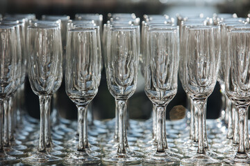 Empty glass transparent wine glasses on a table, catering background concept
