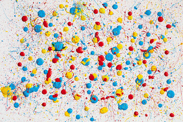 Blue,  yellow and red paint drops on white canvas. Ukrainian flag with blood concept .