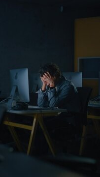 Vertical Screen: Stressed Male Student Sitting Alone in College Informatics Room, Working Late Evenings on Computer Science Project. Tired Scholar Study IT on Computer in University, Writing Homework.