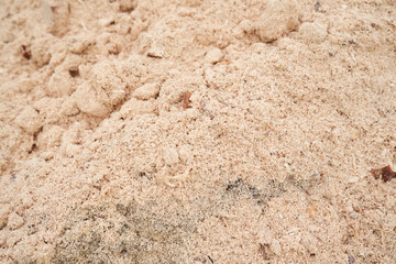 Sawdust stacked in a slide. The background is made of natural sawdust. Recycling of woodworking waste in the workshop. High quality photo