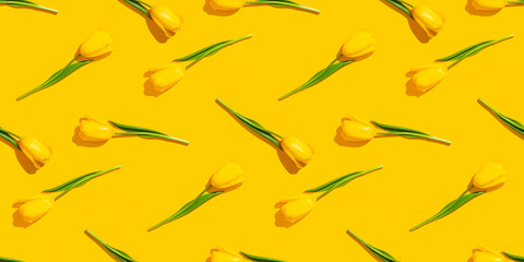 Fototapeta na wymiar Yellow tulips seamless pattern on a yellow background.