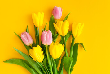 Bouquet of tulips on a yellow background