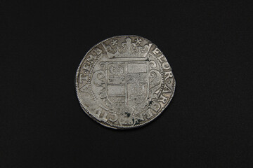 Medieval silver European coin on black background