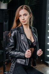 Naklejka premium Fashion model in leather jacket and bra