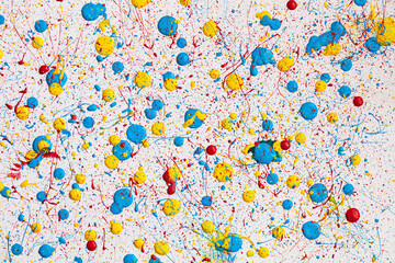 Blue,  yellow and red paint drops on white canvas. Ukrainian flag with blood concept .