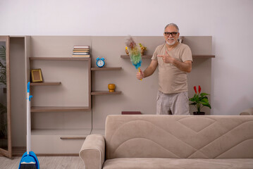 Old man doing housework at home