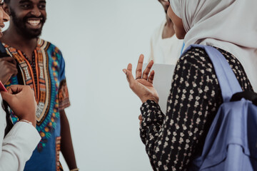 Group of happy african students having conversation and team meeting working together on homework girls wearing traidiional sudan muslim hijab fashion