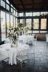 Table decoration for a special occasion - white plates and green plants. Eco/nature friendly decoration.