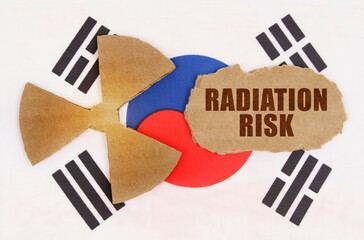 On the flag of South Korea, the symbol of radioactivity and torn cardboard with the inscription - radiation risk