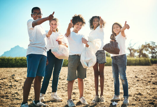 All Green, All Green, All Good. Shot Of A Group Of Teenagers Picking Up Litter Off A Field And Showing Thumbs Up At Summer Camp.