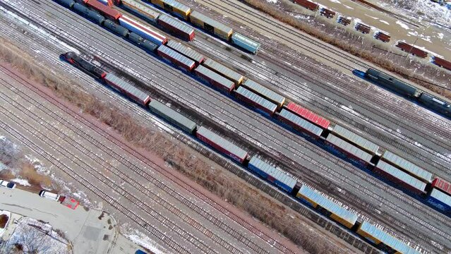 0004456672 freight train rolling into industrial area
