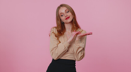 Cheerful rich businesswoman girl showing wasting or throwing money around hand gesture, more tips dreaming about big profit body language. Young woman posing isolated on pink studio wall background