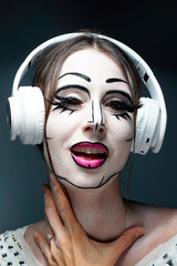 Young beautiful clown woman with white skin and black eyes . Vampire Halloween . Creative make-up. 