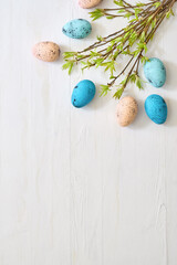 Branches with green leaves and easter eggs on a light background. Happy easter flat lay concept