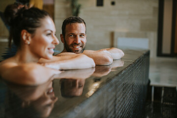 Young couple relaxing in a swimming pool