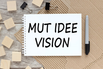 Mut, Idee Vision . text on open notebook near wooden cubes