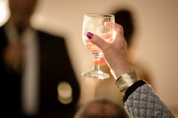 Glass held up for a  toast