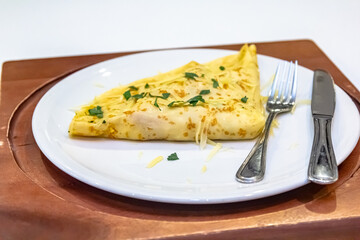 Russian pancakes with stuffing and sprinkled with grated cheese