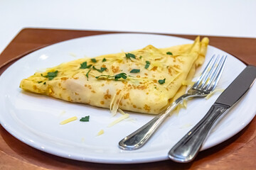 Russian pancakes with stuffing and sprinkled with grated cheese